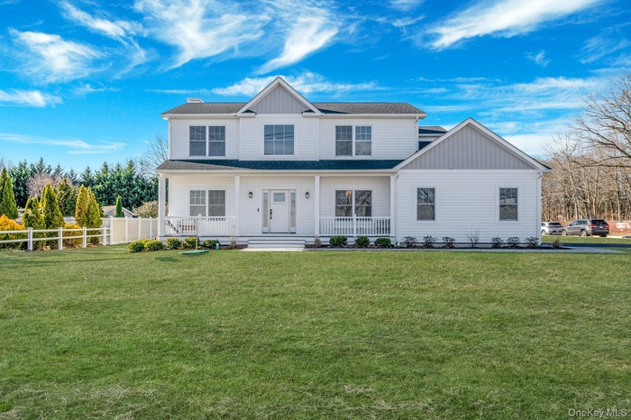 View of front of property with covered porch, roof with shingles, and board and batten siding