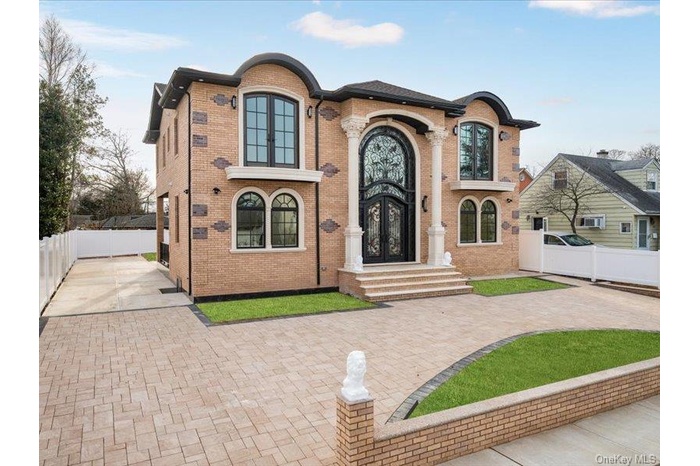 French country home with brick siding