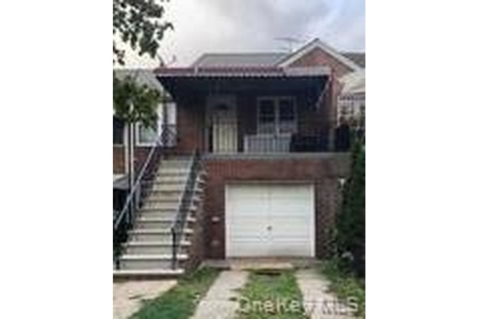 View of front of home featuring stairway and a balcony