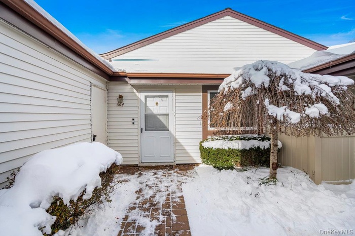 View of snow covered property entrance