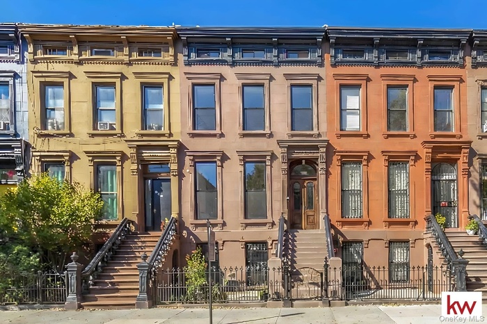 Italianate house featuring a fenced front yard and a gate