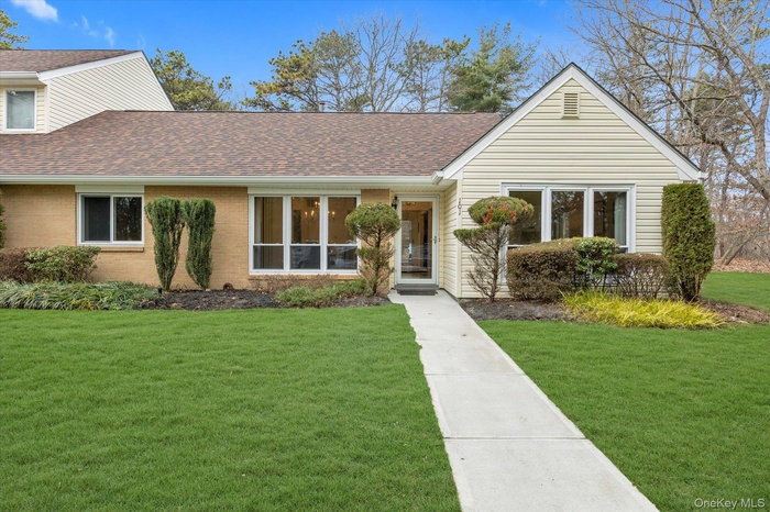 View of front of property with a front lawn, 2023 new roof with shingles, brick and vinyl siding