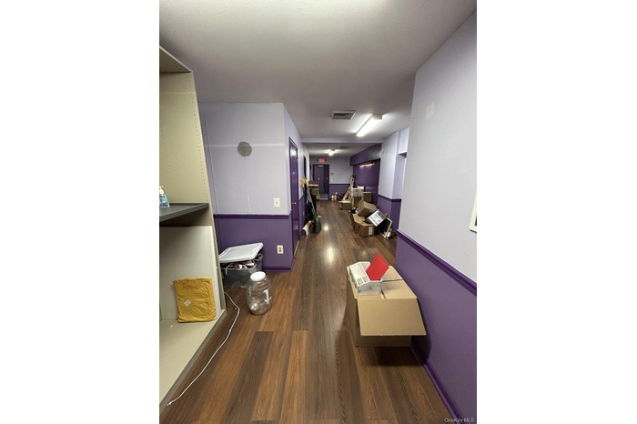 Hall featuring dark wood-style floors