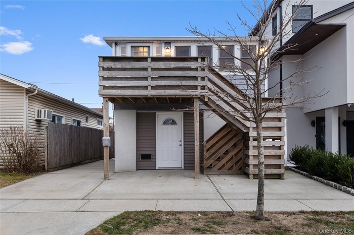 View of exterior entry with a wall unit AC