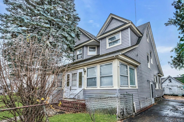 View of front of home featuring a shingled roof