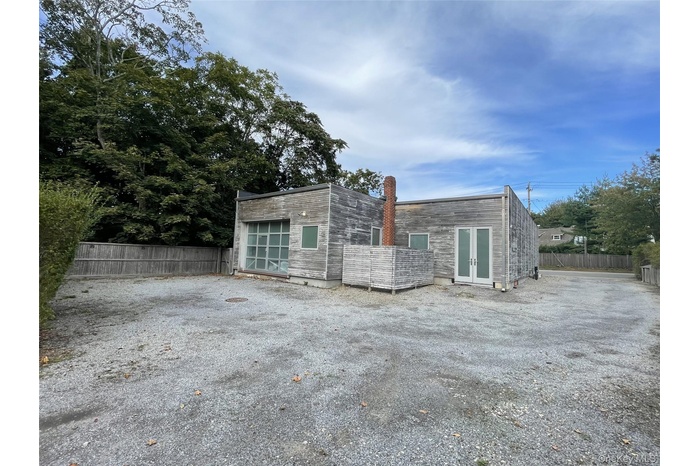 Back of house featuring french doors and a chimney