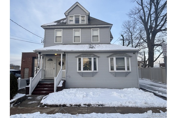 American foursquare style home featuring covered porch