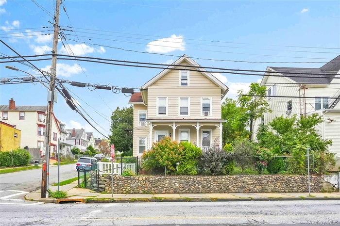 Traditional-style house featuring a fenced front yard