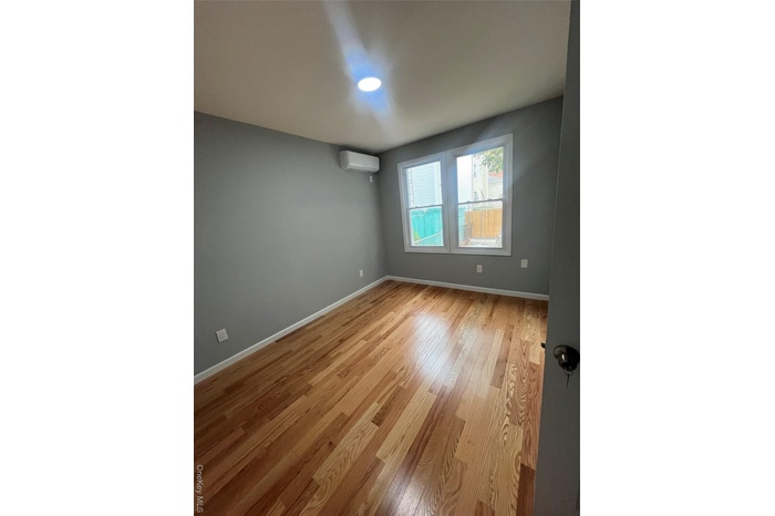 Empty room featuring light wood-style flooring and baseboards