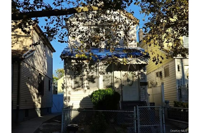 View of property exterior featuring a gate