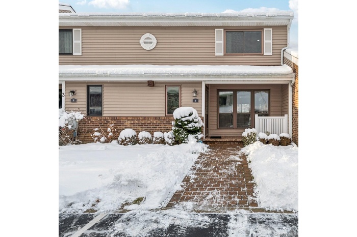Traditional-style home featuring covered porch and siding