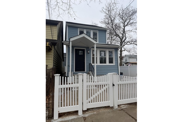 View of front of property with a gate and a fenced front yard