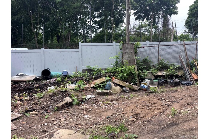 Fenced backyard with a vegetable garden
