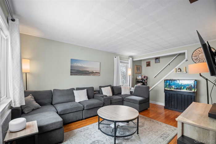 Living area featuring radiator and wood finished floors