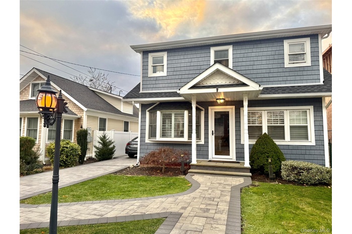 View of front of home with roof with shingles