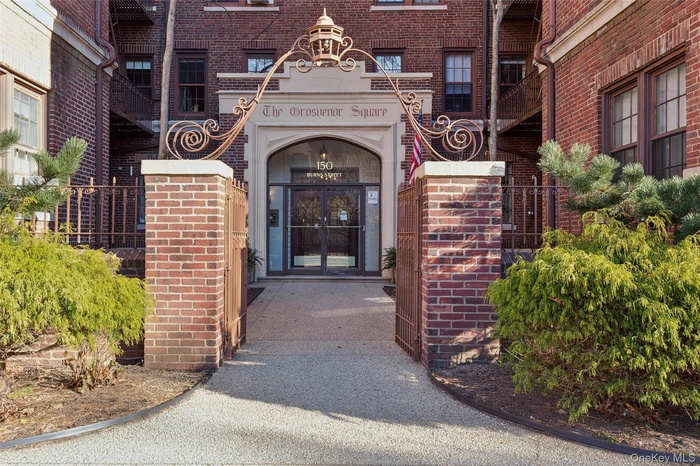 Doorway to property with brick siding and french doors