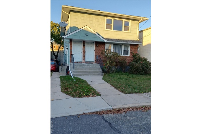View of front of property featuring brick siding and a front yard