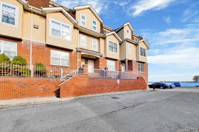 View of front of home with stucco siding, a residential view, and brick siding