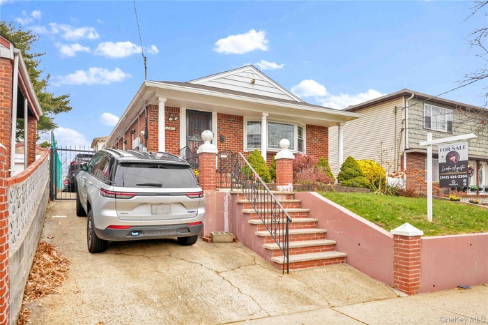 View of front of house with brick siding and stairway