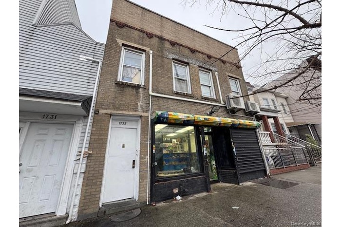 View of property featuring cooling unit and brick siding