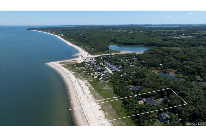 Aerial overview of property's location featuring a large body of water and property boundaries highlighted