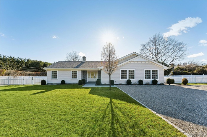 View of Ranch-styled home with a chimney.