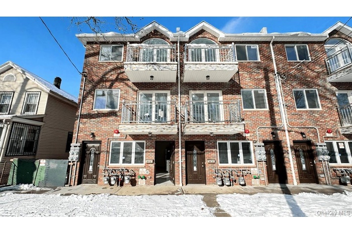 Traditional-style house with a balcony and brick siding