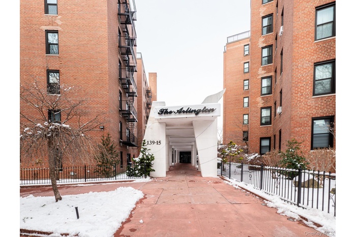 Snow covered property featuring a view of apartment building / complex