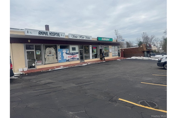 View of commercial location featuring uncovered parking