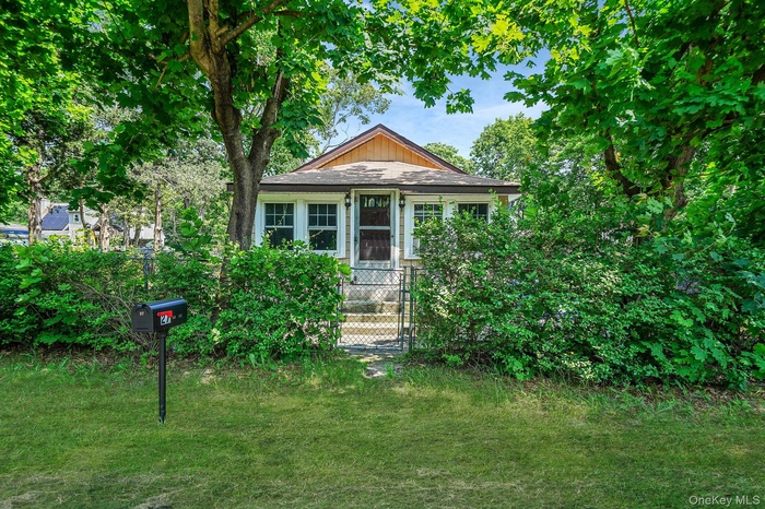 Bungalow-style house featuring a front lawn