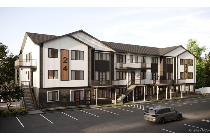 View of apartment building / complex with stairway and uncovered parking
