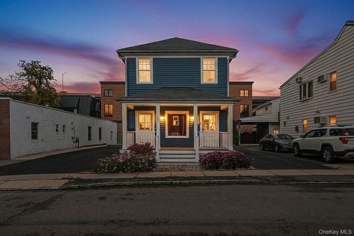 Traditional style home featuring covered porch