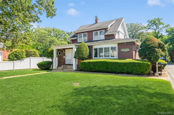 Traditional home with a chimney and brick siding