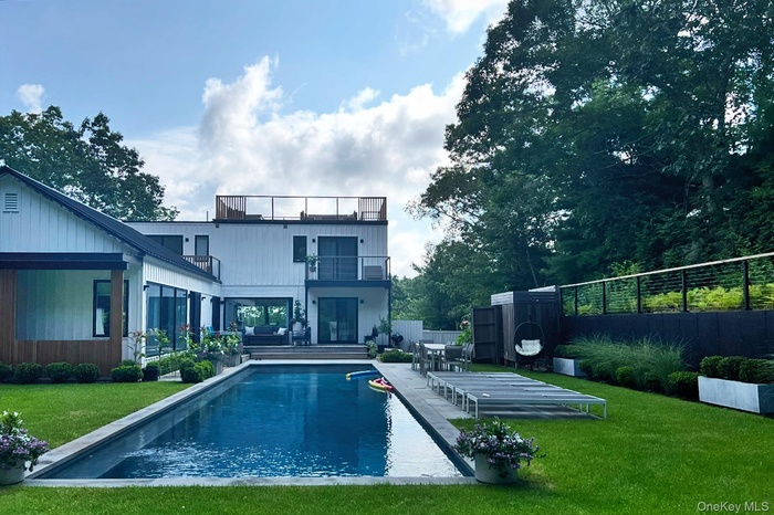 Back of property featuring a patio area and a balcony