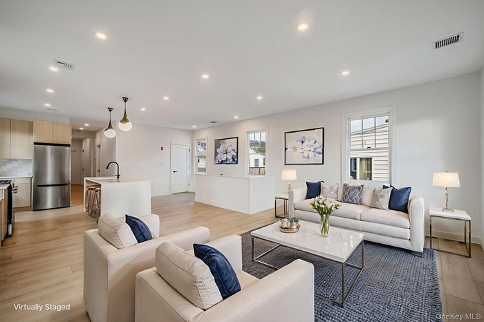Living room with recessed lighting and light wood finished floors