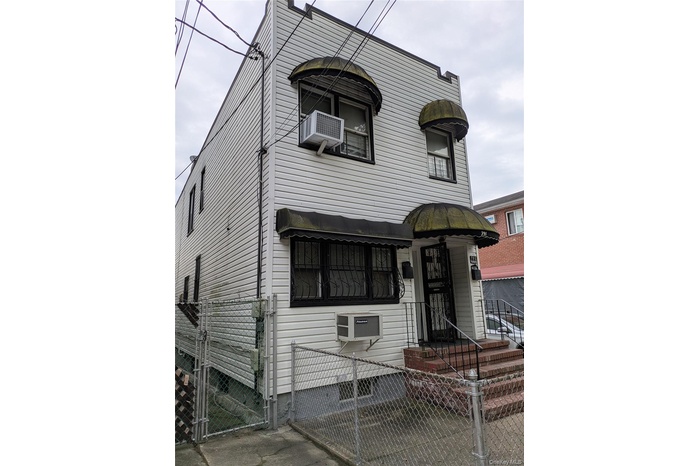 View of front of home with a gate and a fenced front yard