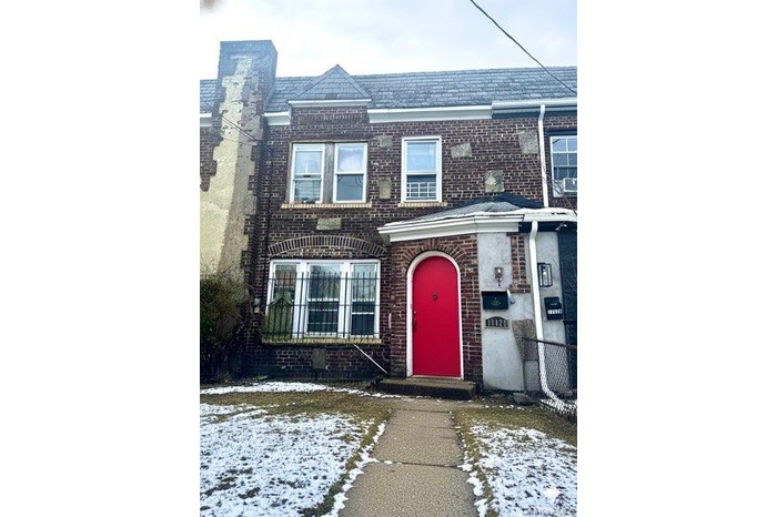 View of front of house with brick siding and a high end roof