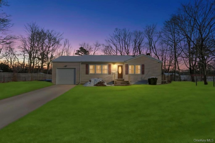 Ranch-style house with a garage and concrete drivewayGrass Photoshopped
