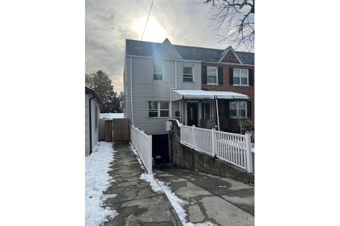 Traditional home featuring covered porch and a gate