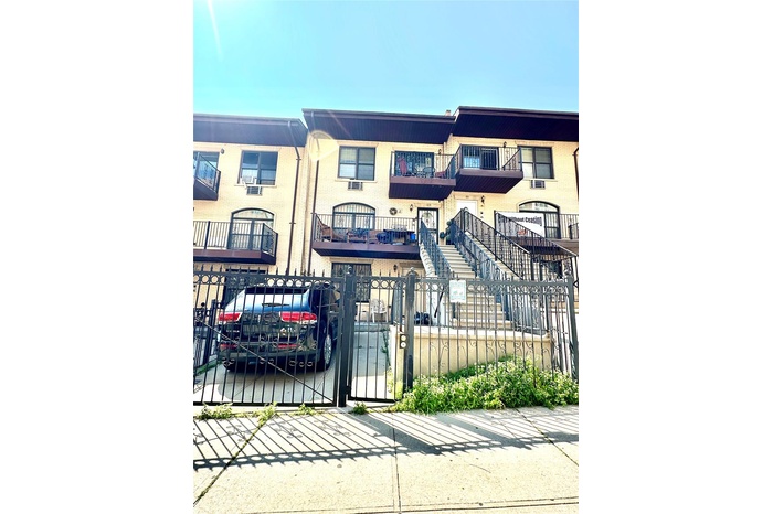 Multi unit property featuring a fenced front yard and a gate