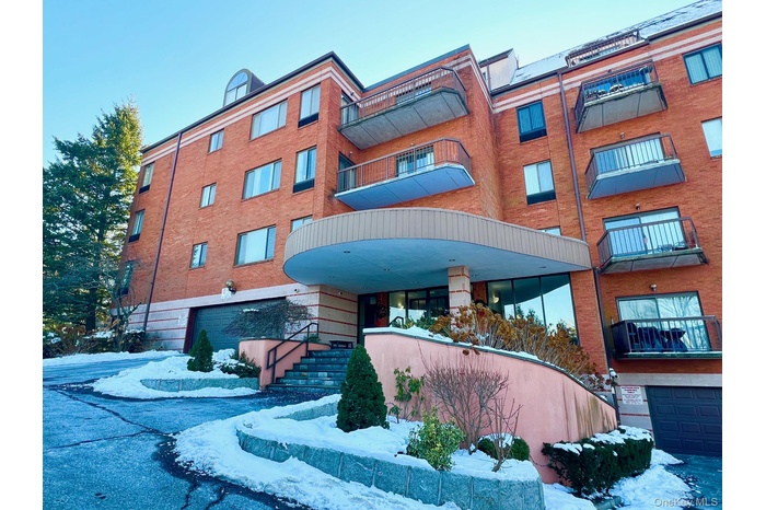 View of apartment building / complex with an attached garage