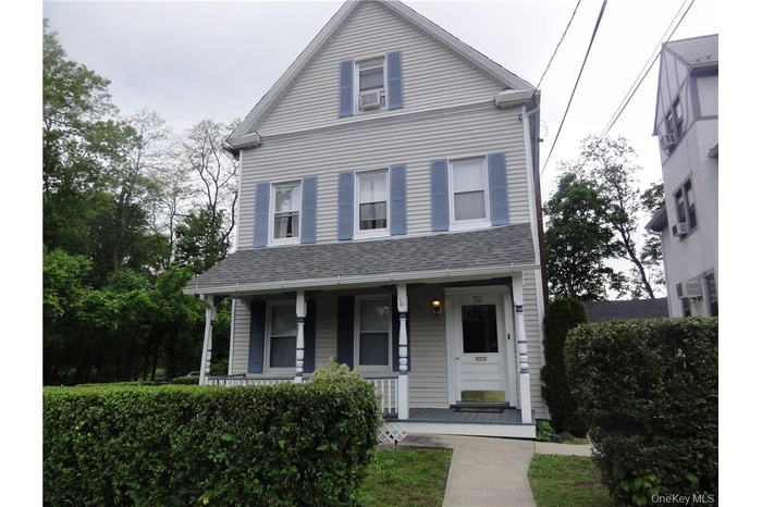 View of front of home with a porch and cooling unit