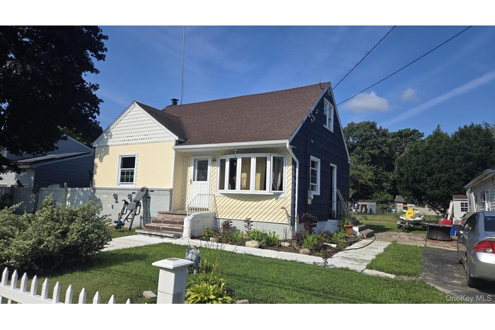 View of front of home with roof with shingles