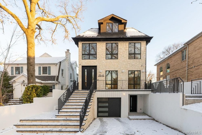 American foursquare style home with stairs and an attached garage