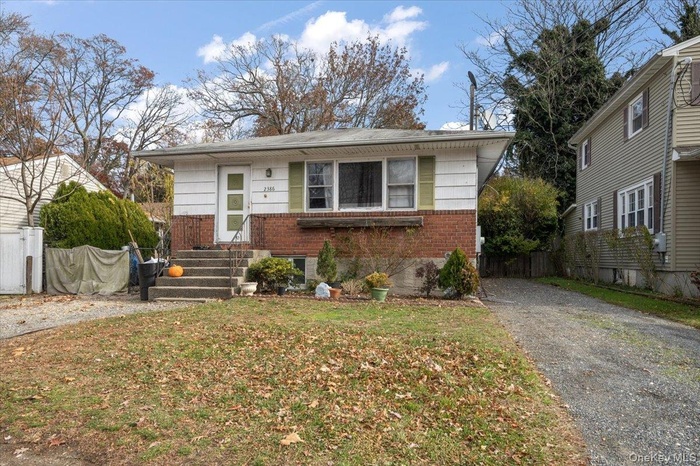 View of front of house featuring brick siding and driveway