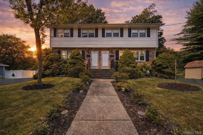 Colonial inspired home featuring brick siding