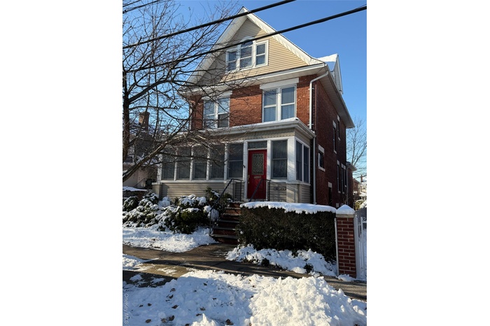 American foursquare style home with brick siding