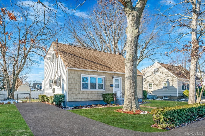 View of front of house featuring a shingled roof