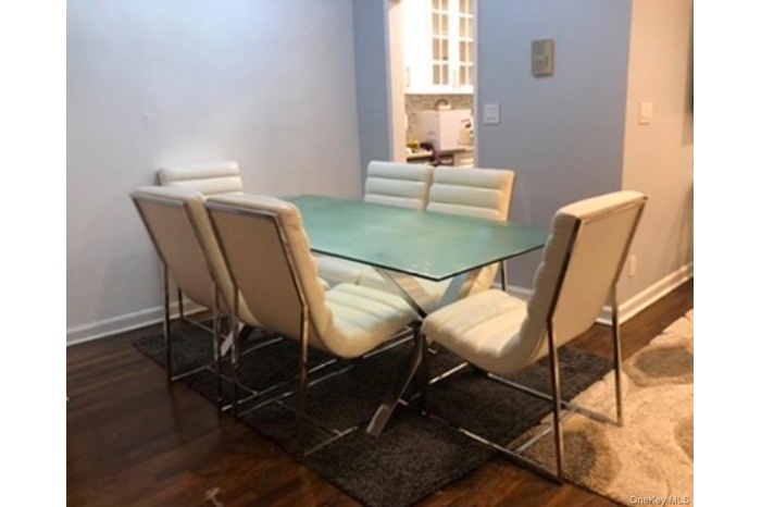 Dining room with dark wood-type flooring