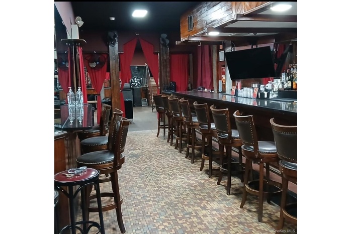 Indoor dry bar with dark countertops